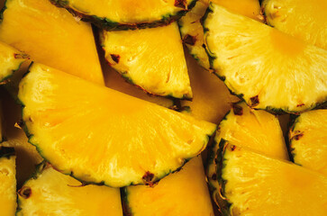 Pineapple juicy yellow slices background. Top view.