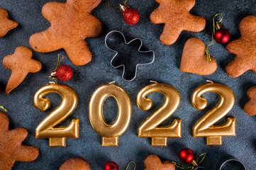 Homemade gingerbread cookies on dark background. Christmas composition, new year background. Number 2022 with cookies. Christmas dessert. New Year flatlay.