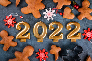 Homemade gingerbread cookies on dark background. Christmas composition, new year background. Number 2022 with cookies. Christmas dessert. New Year flatlay.