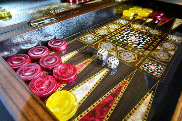 Colorful Turkish backgammon board during the game with yellow and red stones, double six on the...