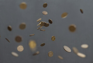 coins fall from above on a dark background