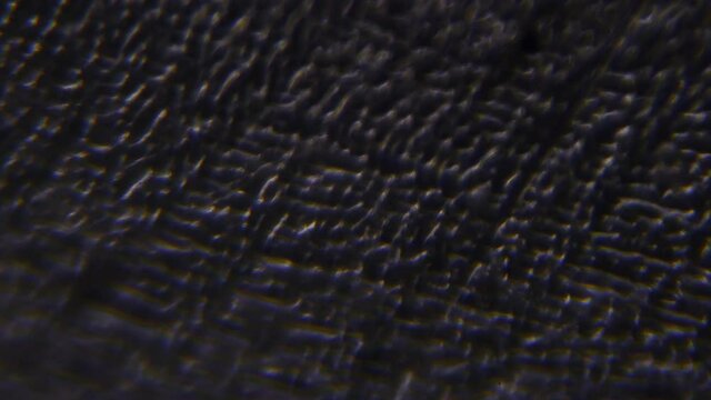 Anti-corrosion nano-coating. Chemical electrical galvanization of metal. Thin zinc surface. Smooth movement under the lens of a geological microscope. Research study of the oxidation resistance