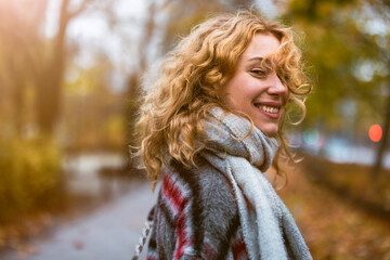 Happy young woman in autumn park
