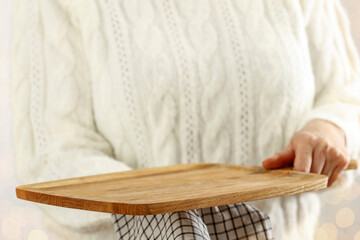 Wooden empty tray in hands on white soft background with vacant on Christmas day 