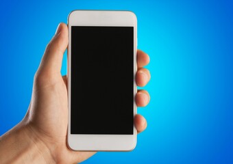 Human hand holding a phone with a blank screen