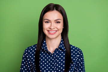 Photo of happy nice young woman good mood face wear blue dotted shirt isolated on green color background