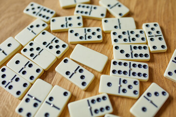 Top view of white domino games on wooden table background with copy space, board game concept