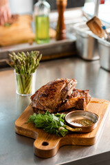 Delicious roasted meat with greens on cutting board