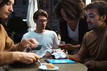 Diverse colleagues preparing business plan while using tablet computer and smartphone