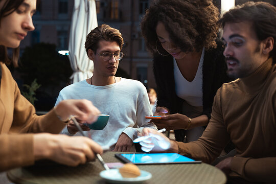 Diverse colleagues preparing business plan while using tablet computer and smartphone