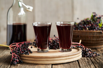 Black elder juice with fresh elderberries