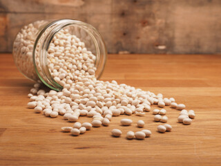 Organic white beans in a canning jar on a kitchen table