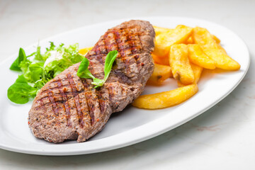 beef steak with homemade french fries and vegetable salad