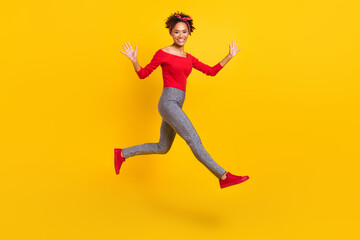 Fototapeta na wymiar Photo of cheerful excited lady jump run hurry rush wear pin-up outfit headband isolated yellow color background