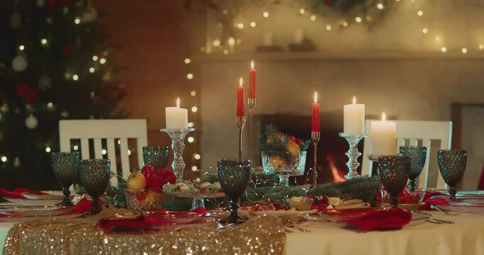 Christmas Festive Table served with Dishes for Celebrating Holiday,  Fireplace with Garland