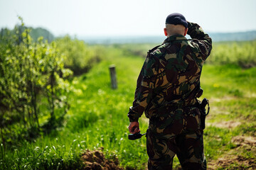 a pistol in a holster on the belt of a special forces soldier. shooting range