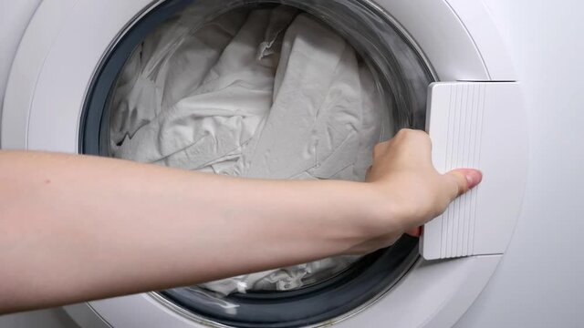 Closing the washing machine. Laundry.