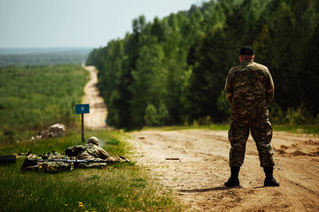 Fototapeta premium soldiers and an officer in military uniform at the training ground