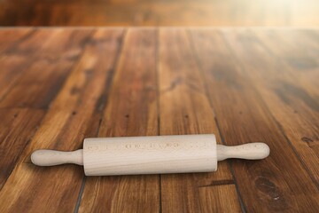 Wooden rolling pin, on rustic wood background. Kitchen utensils on the desk