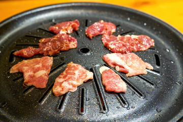 Close-up of grilled pork belly on Korean barbecue grill pan