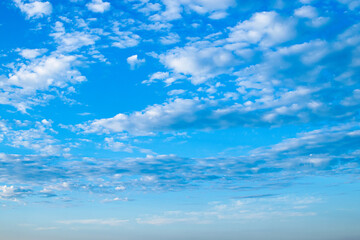 Naklejka na ściany i meble White clouds in sunny weather against blue sky.