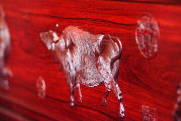 Close-up of cow relief on Chinese mahogany furniture