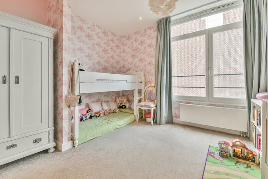Interior Of Kid Bedroom With Pink Walls And Wooden Furniture