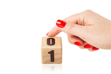 Hand flips the cube from number 0 to number 1 isolated on white background.