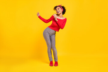 Photo of lovely cheerful inspired lady dance 90s disco wear pin-up outfit shiny pants isolated yellow color background