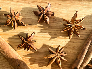Aroma anise stars and cinnamon sticks isolated on wooden background.