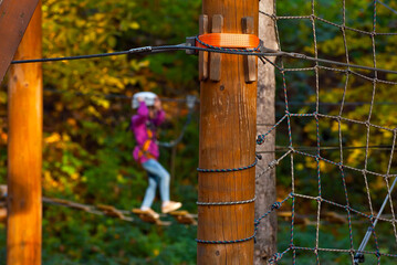 Rope park for children. Extreme outdoor entertainment. Slings, ropes and wires are tied to trees.