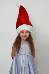 Cute girl with christmas gift box on a white background