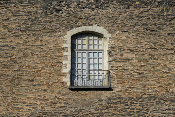 A lonely window in an old historic wall.