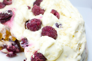 Tasty homemade cake with cream, fresh cherries and raspberry.