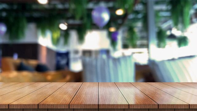 Empty wooden table top with lights bokeh on blur restaurant background.