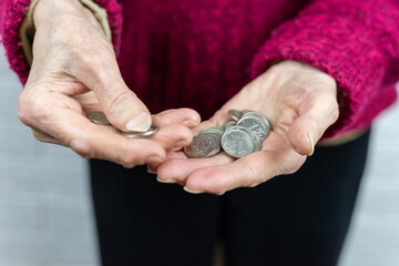coins in the hands of a pensioner.