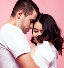 Fototapeta premium young cheerful caucasian couple together having fun on pink background, guy ang girl modern relationship, lifestyle people concept