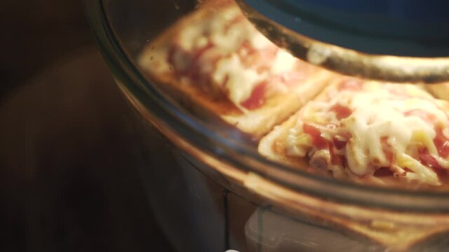 Baking homemade pizza with bread and cheese in dirty electric glass air fryer oven