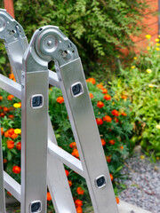 Aluminium multipurpose ladder standing outside.
