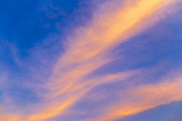 Obraz premium Abstract nature background. Dramatic blue sky with orange colorful sunset clouds in twilight time