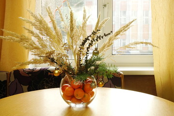 Christmas natural spruce bouquet with dry branches and pampas in vase on table. For decorations at home winter. New Year concept.	