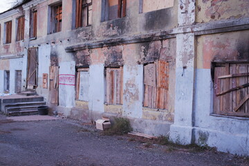 Fototapeta na wymiar An ugly old house before redevelopment with «impeachment» graffito just before the entry