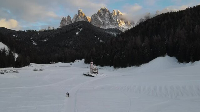 Famous church in Villn&ouml;&szlig;. Church in winter and in the background the Dolomites