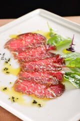 Fine dining, Kobe Beef carpaccio with black salt on the plate