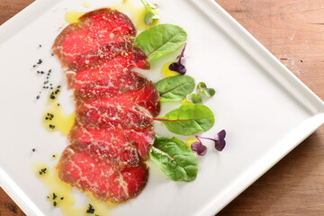 Fine dining, Kobe Beef carpaccio with black salt on the plate