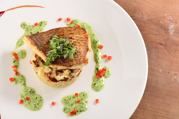 Tasty healthy fish fillet with potato puree with dried tomatoes and wild garlic sauce - obrazy, fototapety, plakaty