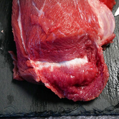 tenderloin veal meat for steaks fillet mignon on black board. Top view.