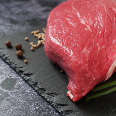 tenderloin veal meat for steaks fillet mignon on black board. Top view.