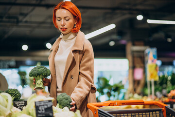 Woman buying fresh vegetables at super market