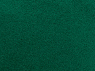 Felt dark green soft rough textile material background texture close up,poker table,tennis ball,table cloth. Empty new fabric background..